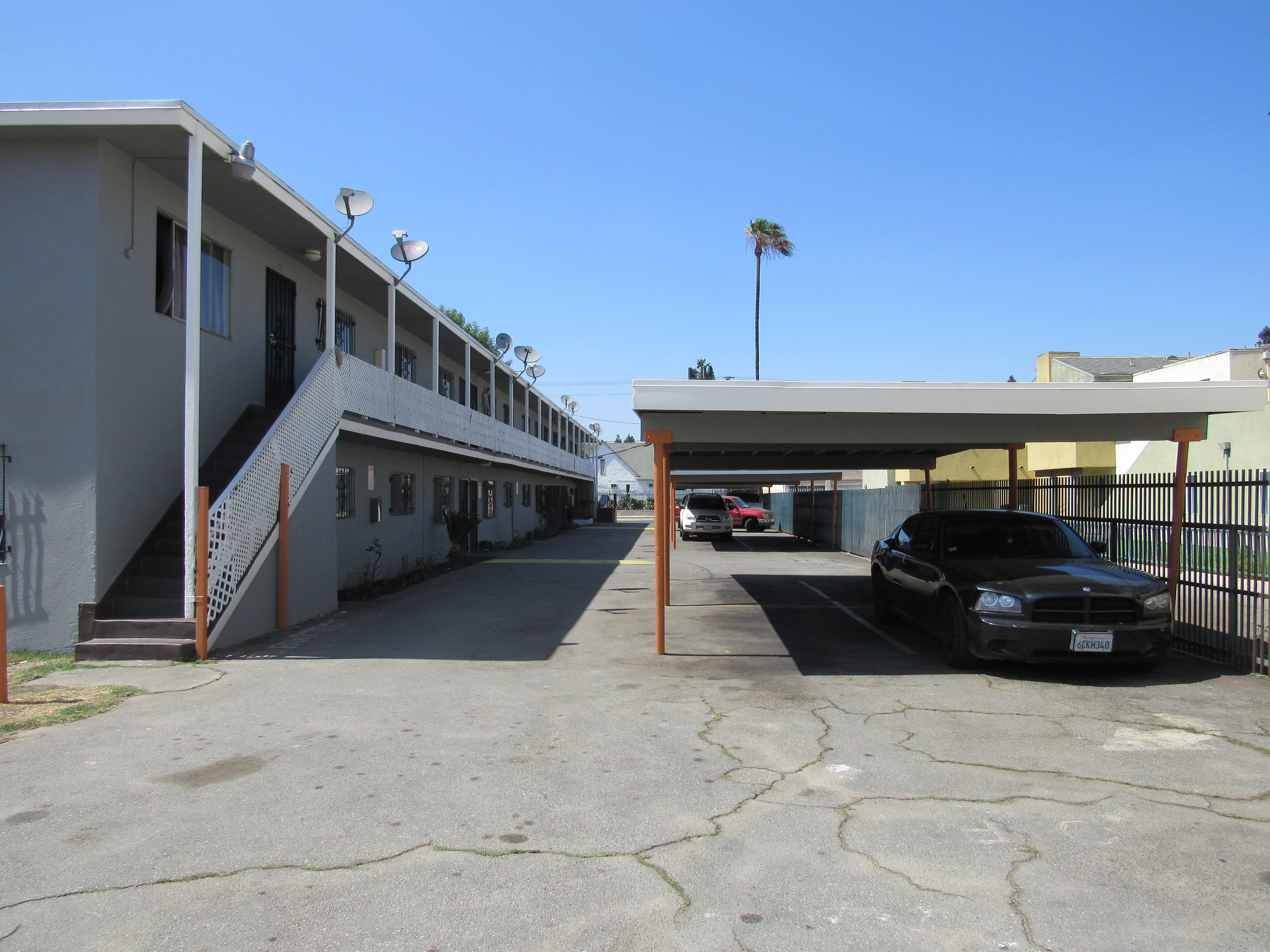 A black car is parked in a parking lot.